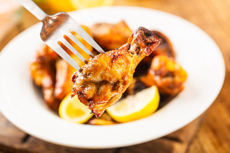 A plate of delicious lemon chicken wingsの写真素材