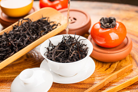 Brewing Chinese tea in ceramic gaiwan during the tea ceremony close-up.の写真素材