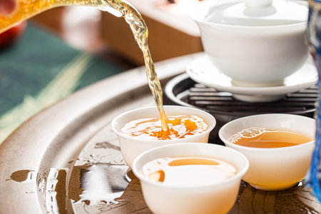 Brewing Chinese tea in ceramic gaiwan during the tea ceremony close-up.の写真素材