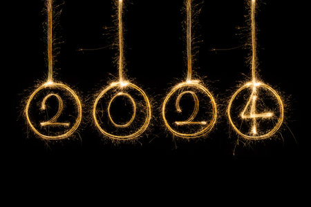 Happy New Year 2024. Sparkling burning text Happy New Year 2024 isolated on black background.の写真素材
