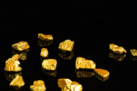 Gold nugget heap on the black background. Macro shooting.