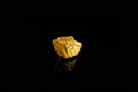 Gold nugget on black background. Gold ore on black background.の写真素材