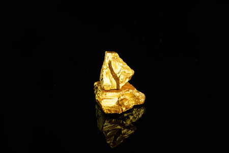 Gold nugget on a black background. Gold nuggetの写真素材