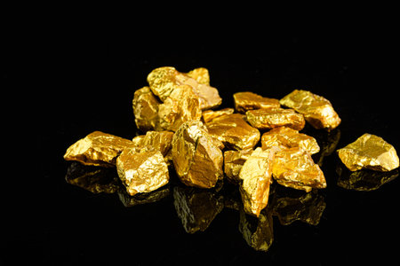 Gold nuggets on black background.の写真素材
