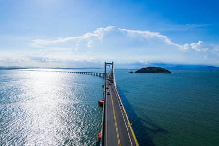 The bridge over the sea with blue sky and white cloud background.の写真素材