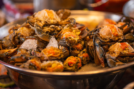 Close-up of cooked crabs in a metal bowl on the table