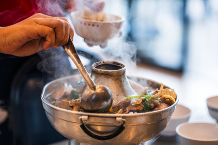 Pouring hot water to hot pot.
