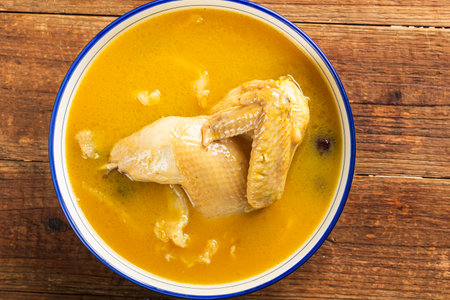 Bowl of curry with chicken on wooden background. Top view.の写真素材