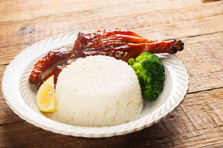 Roast duck with rice and broccoli on wooden table, closeupの写真素材