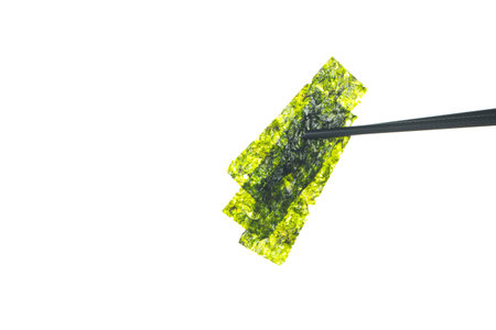 Green seaweed on chopsticks isolated on white background. Japanese food.の写真素材