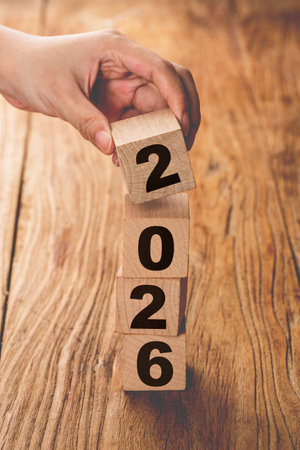 Wooden cubes with numbers 2026 on a wooden table. New year concept
