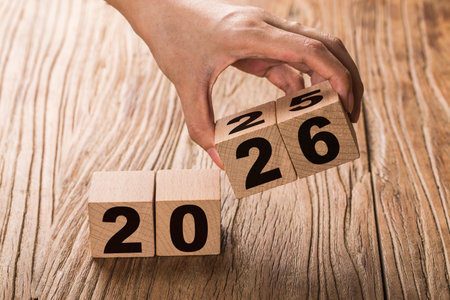 Wooden cubes with numbers on a wooden background. New year concept.の写真素材