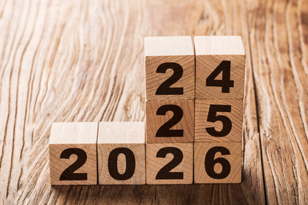 Wooden cubes with numbers on a wooden background. New year concept.