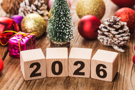 Wooden blocks with new year 2016 and christmas decoration on wooden background