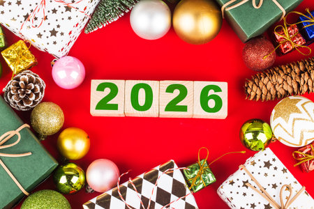 Top view of wooden blocks with number 2016 and Christmas decoration on red background