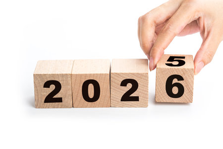 Wooden cubes with the numbers 2026 on a blue background. New year concept.
