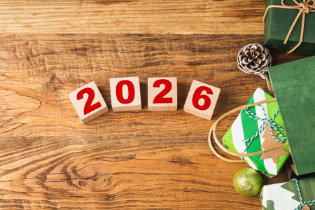 Happy New Year 2026 with Christmas gifts and ornaments on red background