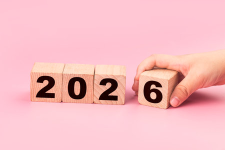 New year concept with wooden cubes on pink background. New year resolution