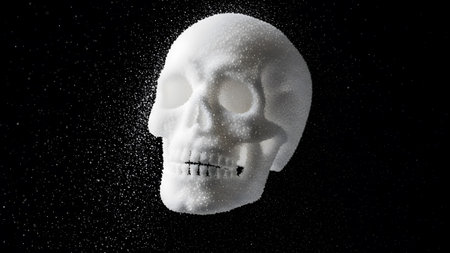 A white granular sugar skull sculpture with sugar crystals scattering around it on a stark black...の写真素材