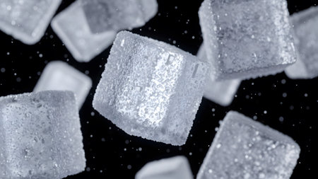 Close-up view of granular sugar cubes falling and floating in a dark space, with light...の写真素材