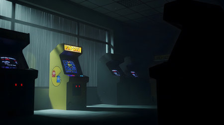 A yellow Pac-Man arcade machine stands in a dimly lit room with a window and other dark cabinets.の写真素材
