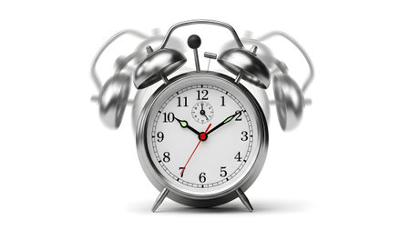 A silver vintage alarm clock with twin bells is depicted in motion blur, indicating it is ringing.