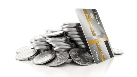 Shiny silver card leaning against stack of shiny metal coins on white background....