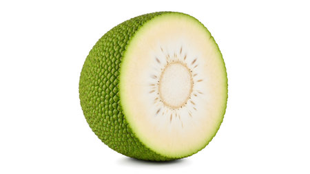 A green breadfruit is presented cut in half, highlighting its bumpy exterior and the......