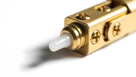 Mechanism showing close-up of brass tool mechanism with white plastic tip and screws.