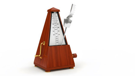 A classic wooden metronome with a brass winding key and a silver pendulum stands on a white...