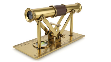 showing antique brass telescope with spirit level on a ruler base.
