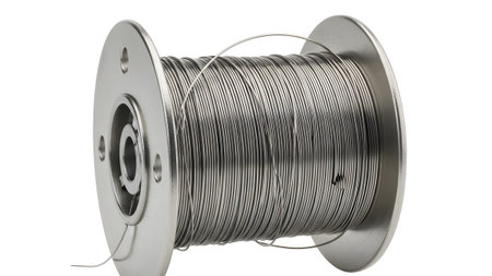 Wire showing spool of thin metallic wire with a silver metal bobbin on a white background.