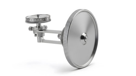 Device showing silver metal measuring device with circular dial and large wheel.