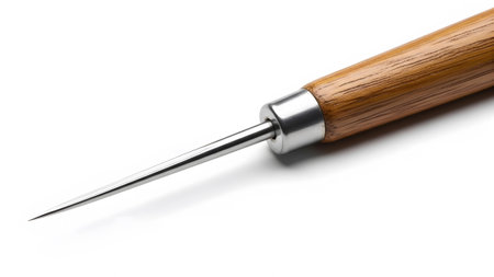 A sharp metal ice pick with a polished wooden handle rests on a clean white background,...