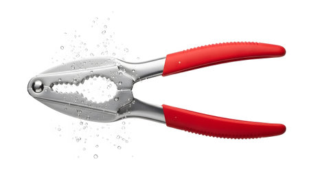 Droplets showing silver nutcracker with red handles and water droplets on white background.