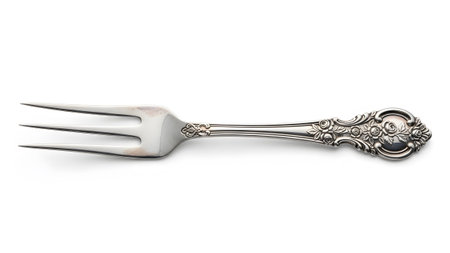 Stock showing ornate silver fork with floral engraving on handle and three tines isolated.