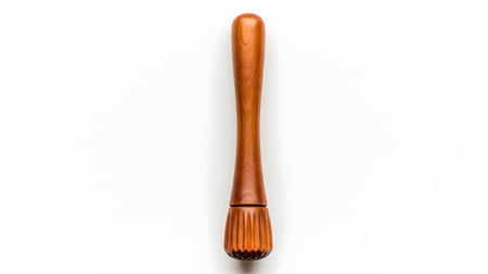 Base showing wooden muddler with fluted base and smooth handle isolated on white background....