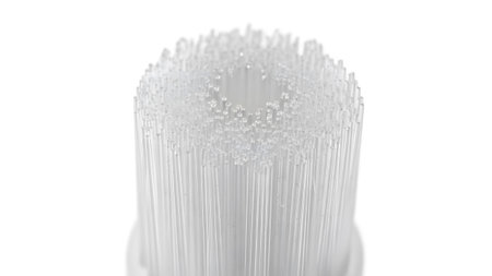 Dense, fine transparent bristles of a brush head are shown in extreme close-up against white.