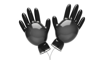showing glossy black latex gloves with transparent cuffs floating on white background....
