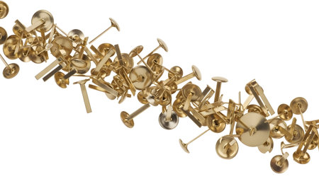 Metal showing scattered golden thumb tacks and push pins with round heads and metal pins on...