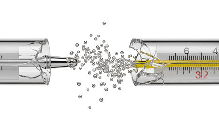 A glass thermometer is shattered, with yellow liquid and silver bubbles exploding outwards on a...