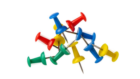 Yellow showing pile of colorful push pins red blue yellow green scattered on white background....