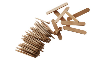 A dynamic composition of wooden craft sticks falling and scattering, with a pile of sticks in a...
