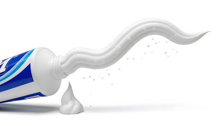 Small showing white toothpaste being squeezed out of a blue and white tube with small water...
