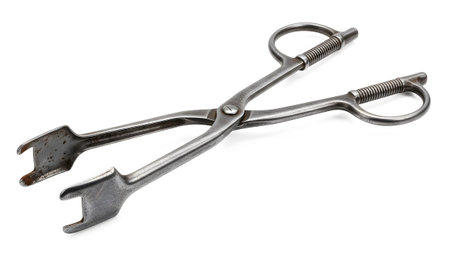 Notched showing antique metal serving tongs with ribbed handles and notched gripping ends on...