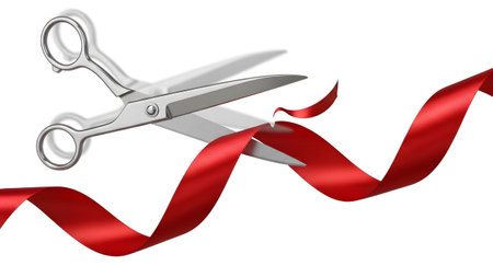 Silver scissors are captured in motion, cutting a vibrant red ribbon with a dynamic blurred...