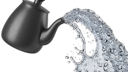 A dark gray teapot with a curved spout is actively pouring a dynamic splash of clear water.