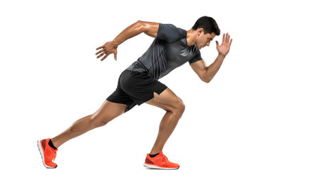 Athletic man in grey t-shirt and black shorts sprinting powerfully on white background....