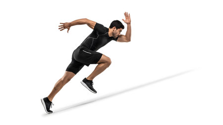 A man in black athletic clothing sprints forward with powerful motion, arms positioned for...