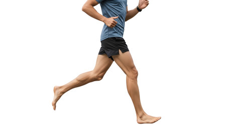 Close-up side view of a barefoot male runner's legs and torso in motion on white....